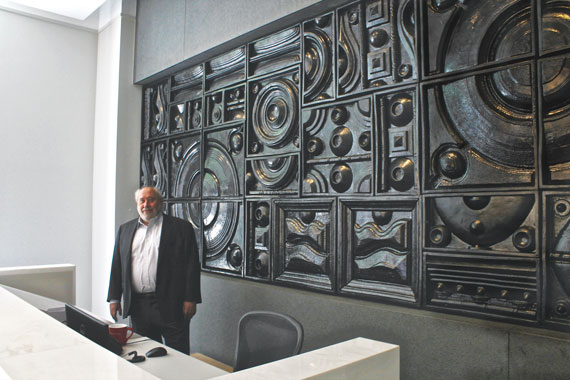 Developer Yitzchak Tessler in the sales gallery of 172 Madison with a piece of art that will soon be installed at the condo tower.