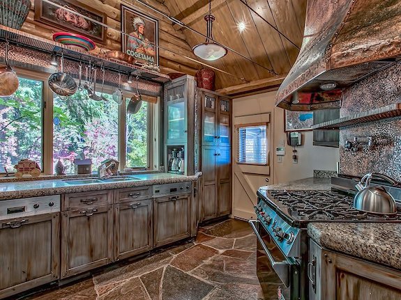 the-kitchen-has-a-rustic-feel-and-a-huge-stove
