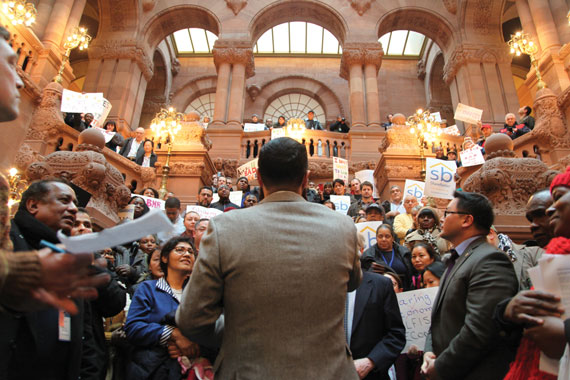 Assemblyman Francisco Moya talking to a crowd at an Airbnb protest in the state capitol building.