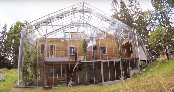 An eco-friendly house built within a greenhouse