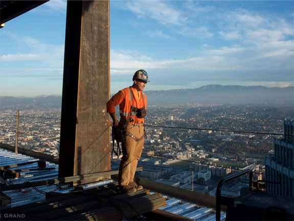 a-construction-worker-stands-on-one-of-the-upper-levels-the-tower-overlooks-the-whole-of-the-city-and-surrounding-mountains