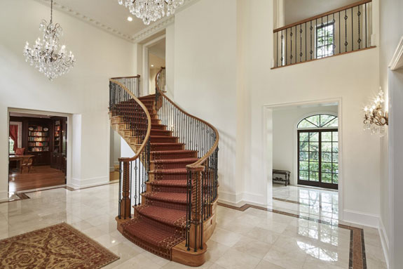 the-s-shaped-staircase-marble-floors-and-chandeliers-make-for-a-dramatic-entrance
