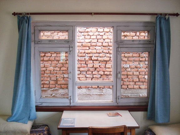 A window opening to a brick wall