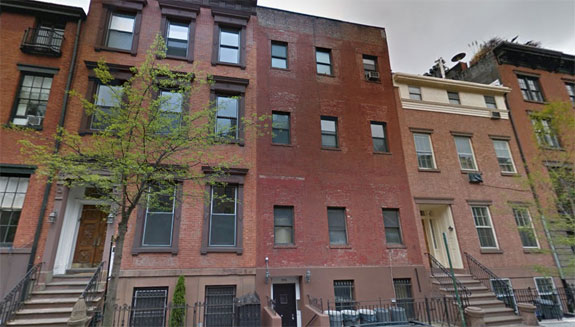 Conversion plans for 442 West 22nd Street, the plain brick building in the center, are currently being blocked by a tenant