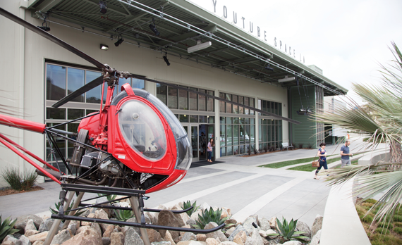 A Hughes 269A helicopter in front of an aircraft hangar once owned by Howard Hughes and now a home for YouTube in Playa Vista.