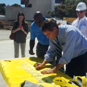 Fort Lauderdale Mayor Jack Seiler signs the Brightline flag Friday at the train station topping-off ceremony.