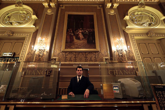 when-visitors-are-ready-to-cash-out-they-can-exchange-their-chips-with-assistant-cashier-gregory-francois-posing-here-in-the-salle-des-ameriques