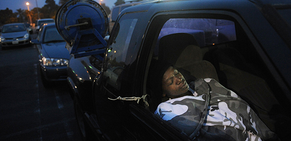 A woman sleeps in her car in Los Angeles (Credit: Mark Ralstone/AFP/Getty Images)
