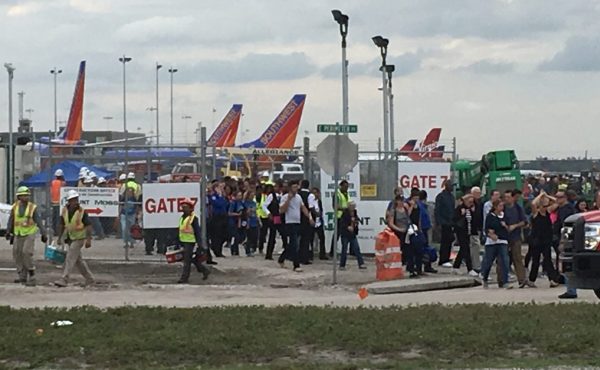 Crowds gather after a mass shooting at Fort Lauderdale-Hollywood International Airport. (Credit: PBS)
