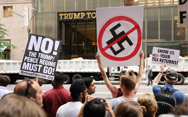 Protesters gather outside of Trump Tower along Fifth Avenue on August 14, 2017 in New York City. (Credit: Getty Images)