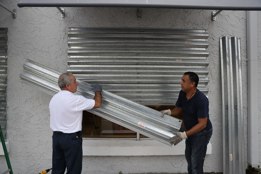 Residents putting on hurricane shutters on Wednesday (Credit: Getty Images)
