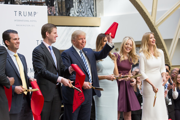 President Donald Trump cutting the ribbon at the Trump International Hotel in Washington, DC (Credit: Getty Images)