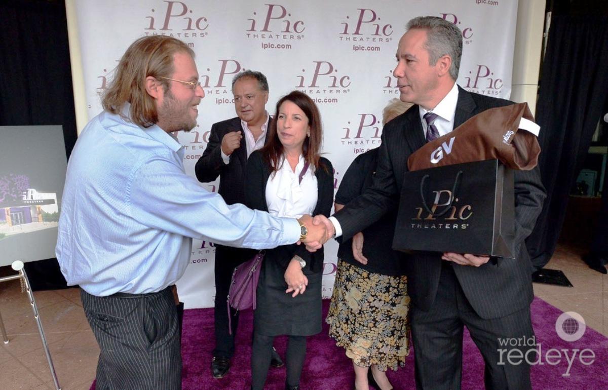 Gil Dezer shakes hands with George Vallejo at a 2015 event to announce a planned iPic movie theater at the Intracoastal Mall in North Miami Beach. (Credit: Worldredeye.com)