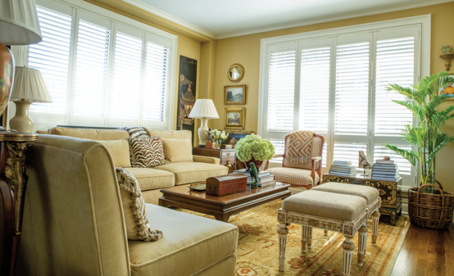 A contemporary sofa and chairs from Pottery Barn are paired with more traditional furnishings in Gunn’s living room.