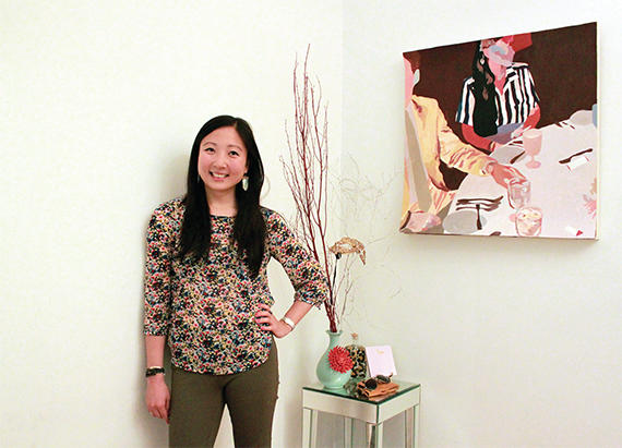 Margaret Wang in her Chelsea home with a painting from Uprise Art to her right (photo: Uprise Art)