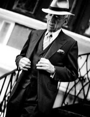 Talese descends the stairs outside his home.