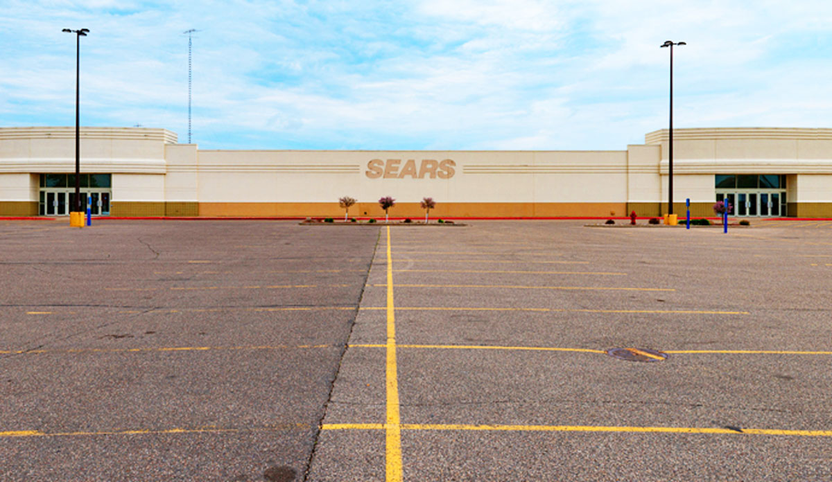 A closed Sears retail store, located at Crossroads Center mall, sits vacant. The building is stained with the Sears logo (Credit: iStock)