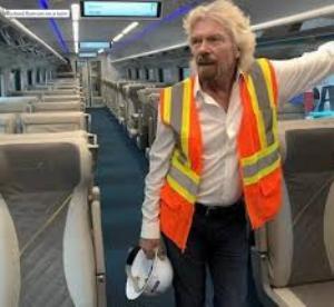 Richard Branson aboard train operated by Virgin Trains USA, formerly known as Brightline (Credit: Virgin Group | Tampa Bay Times)