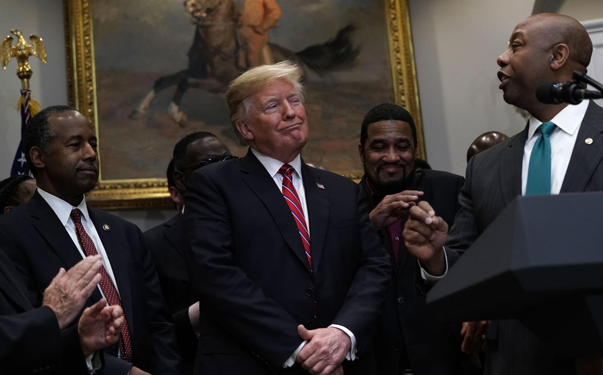 President Trump at the White House Wednesday, where he signed an executive order establishing an Opportunity Zones council. Sen. Tim Scott is at right, at left is Secretary of Housing and Urban Development Secretary Ben Carson. (Getty Images)