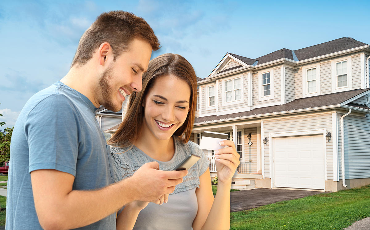 A couple paying their mortgage (Credit: iStock)