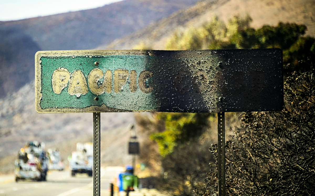 A fire-damaged Pacific Coast sign (Credit: Fredric J. Brown via Getty Images)