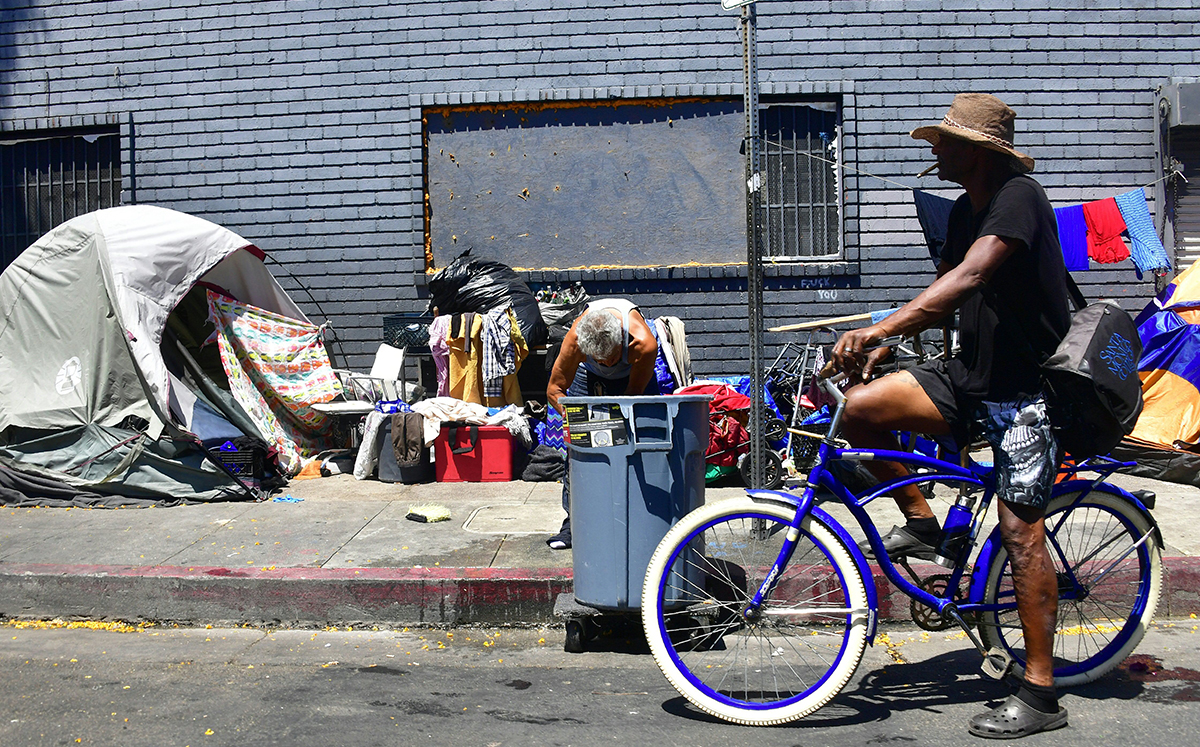 Tents and belongings of the homeless line a street in downtown Los Angeles (Credit: Getty Images)