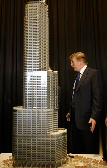 Donald Trump stands next to a model of Trump Tower Chicago in 2003