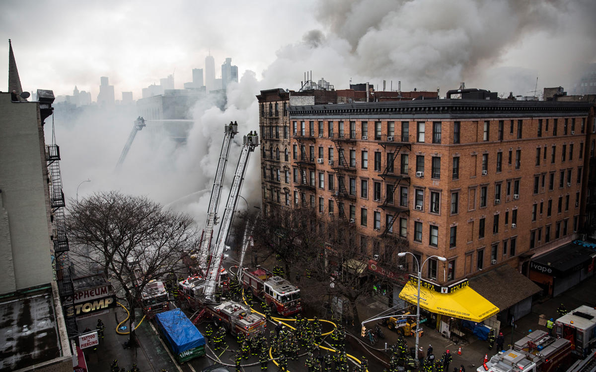 Firefighters work to extinguish a fire as a building burns after an explosion on 2nd Avenue in March 26, 2015 (Credit: Getty Images)