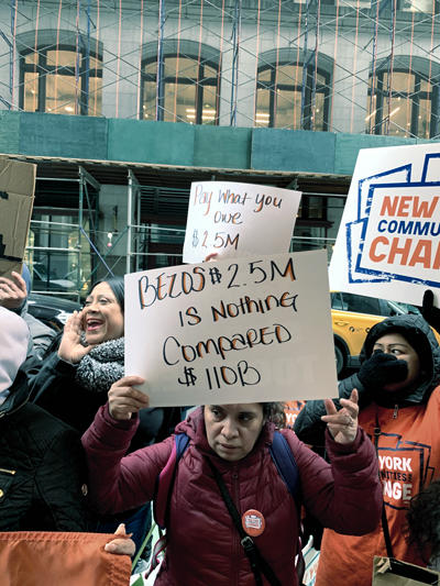 Activists gathered outside 212 Fifth Avenue, calling on Amazon's Jeff Bezos to pay more tax on his Flatiron pied-à-terre (Photo by Erin Hudson)