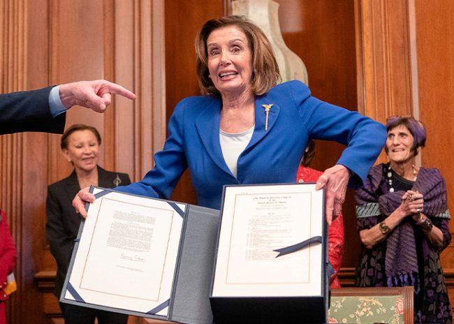 Representative Kevin McCarthy and US Speaker of the House Nancy Pelosi show the $2 trillion stimulus bill (Credit: ALEX EDELMAN/AFP via Getty Images)