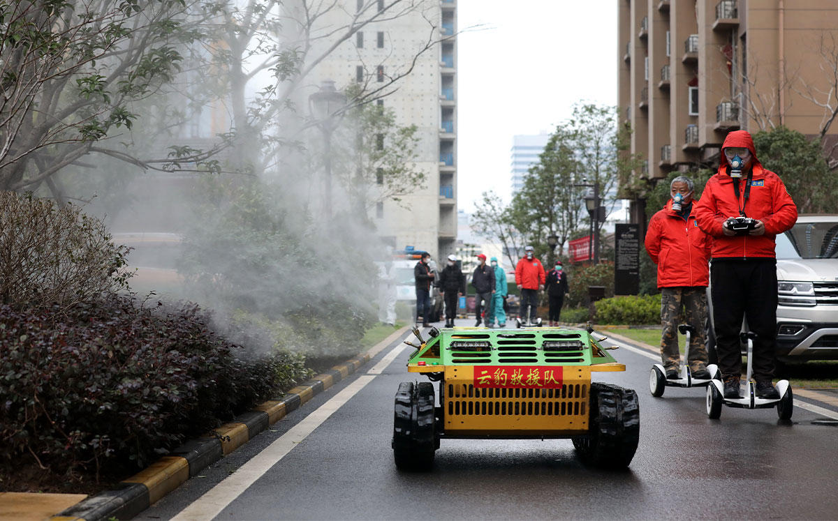 Workers disinfect an apartment complex in Wuhan (Credit: Feature China/Barcroft Media via Getty Images)