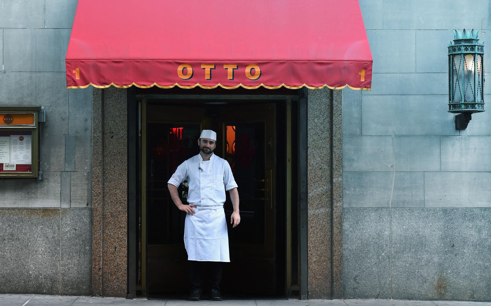 The executive chef of Otto Enoteca stands in front of the closed restaurant caused by the coronavirus pandemic. (Photo by ANGELA WEISS/AFP via Getty Images)