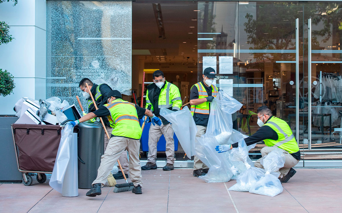 Workers clean up after demonstrations at the Grove Mall (Credit: VALERIE MACON/AFP via Getty Images)