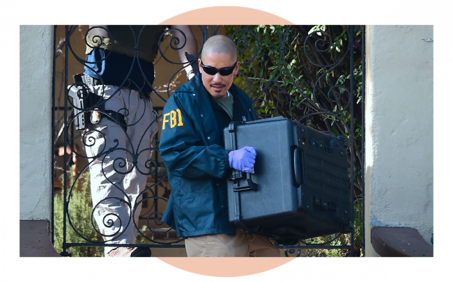 FBI agent carries a case from the home of Los Angeles Councilman Jose Huizar. The FBI served sealed warrants at the home, field and City Hall offices of Huizar. (Credit: FREDERIC J. BROWN/AFP via Getty Images)
