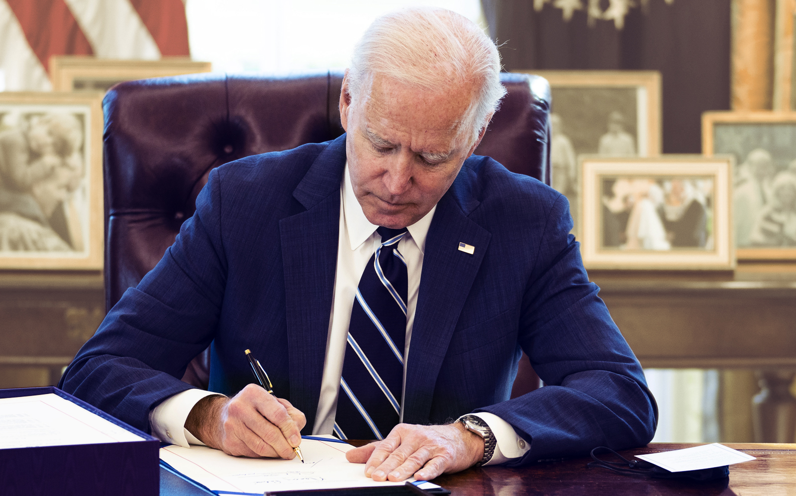 President Biden signing the $1.9 trillion COVID relief bill on March 11. (Getty)