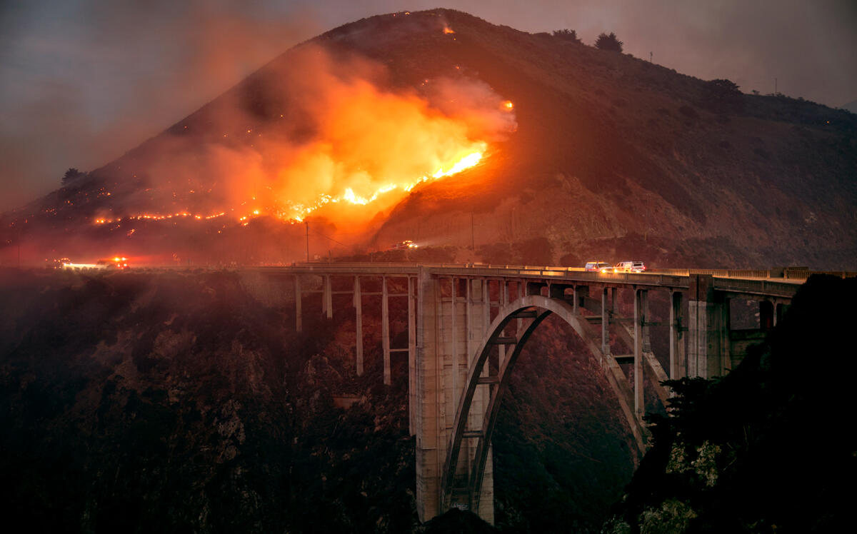 The Colorado Fire burns down toward the Bixby Bridge in Big Sur, California, early Saturday morning. (Photo by Karl Mondon/MediaNews Group/The Mercury News via Getty Images)