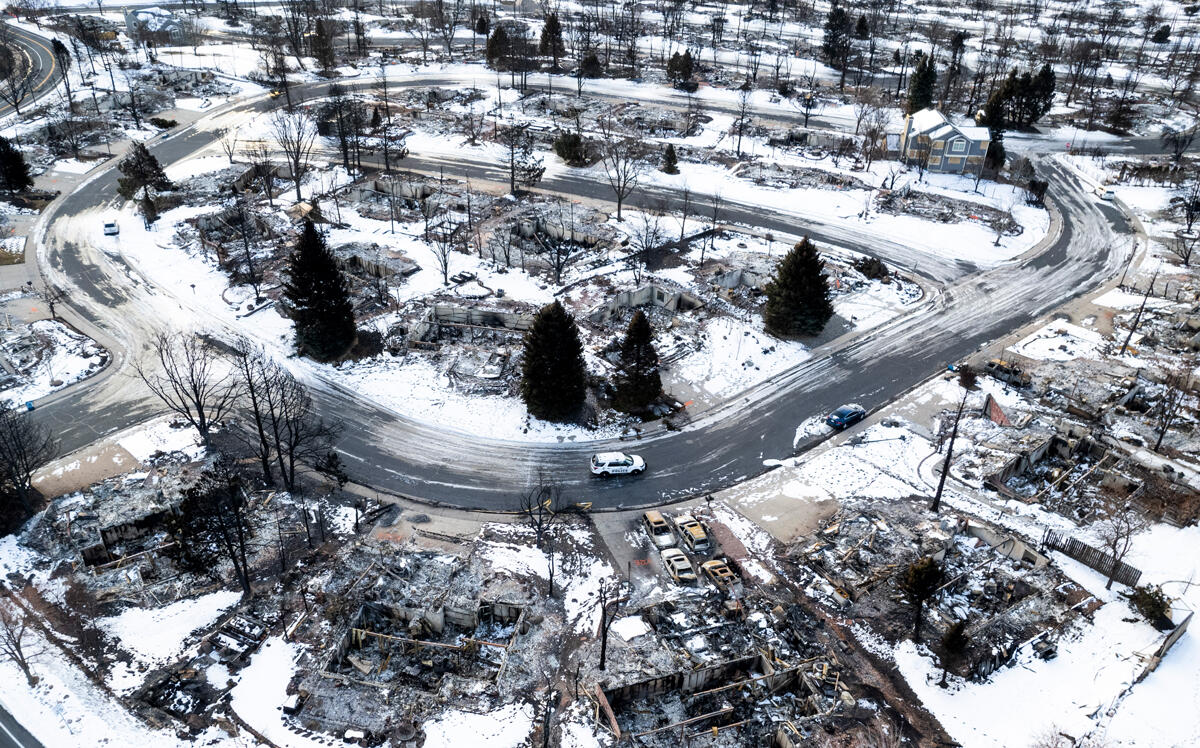 Police patrol a neighborhood decimated by the Marshall Fire on January 4, 2022 in Louisville, Colorado. (Photo by Michael Ciaglo/Getty)