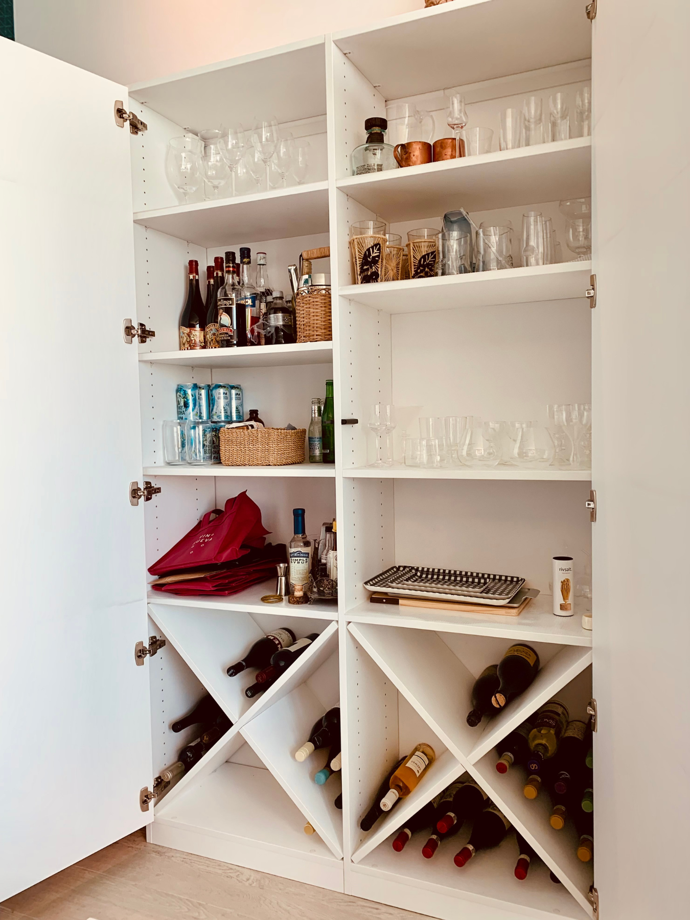 Not everyone has a room designated for a Pantry. For this client we built a custom wall unit that served as additional pantry and bar storage. Simple solutions that make a huge difference.