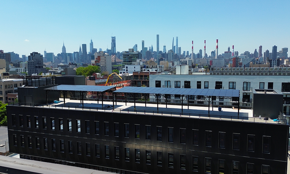 A 50kW black powder-coated solar canopy system powering Ferrara Manufacturing’s newest facility in Astoria.