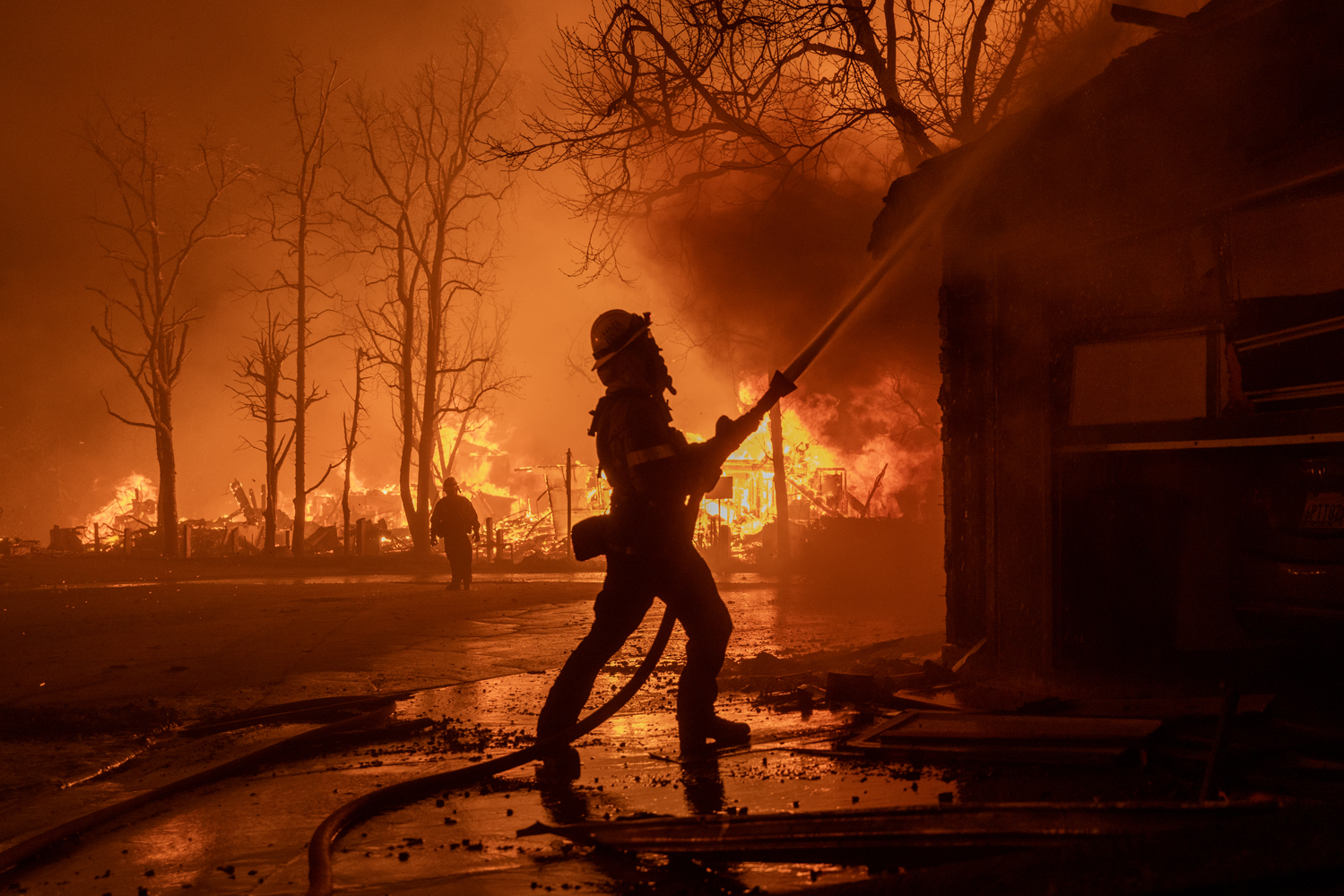 Fires whipped by 99 mph gusts destroy Southern California homes, businesses