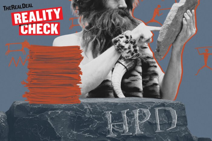 Caveman at desk with paperwork